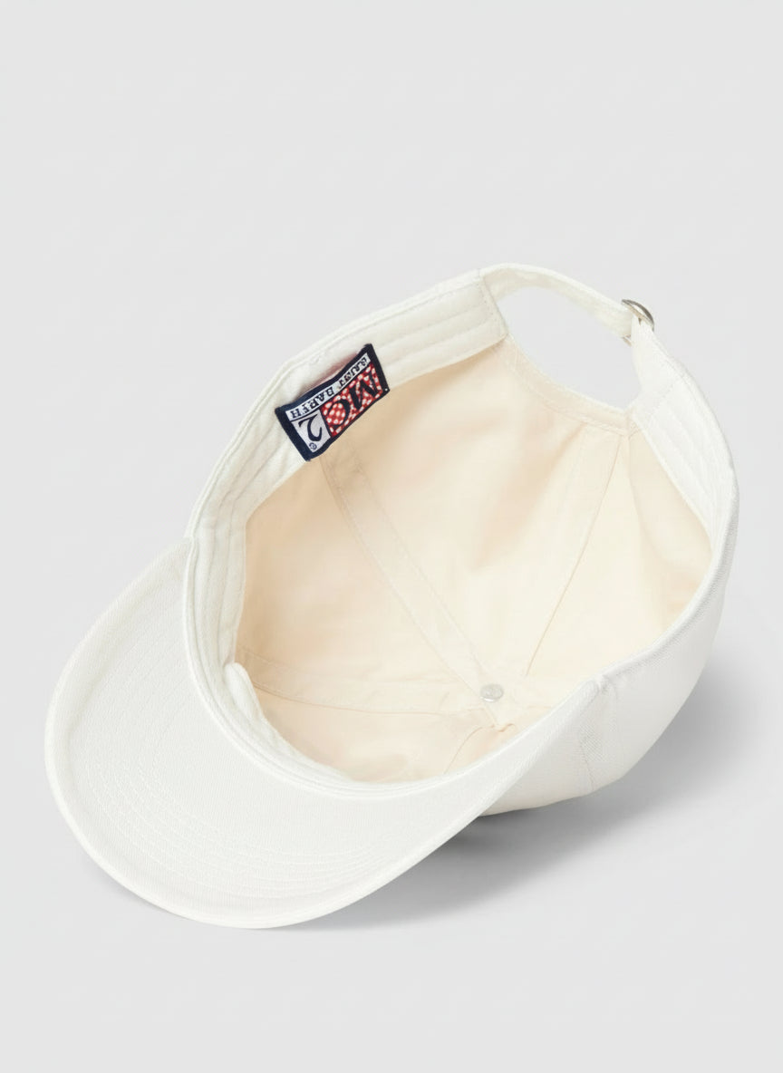 White visor with colorful patches on a light gray background