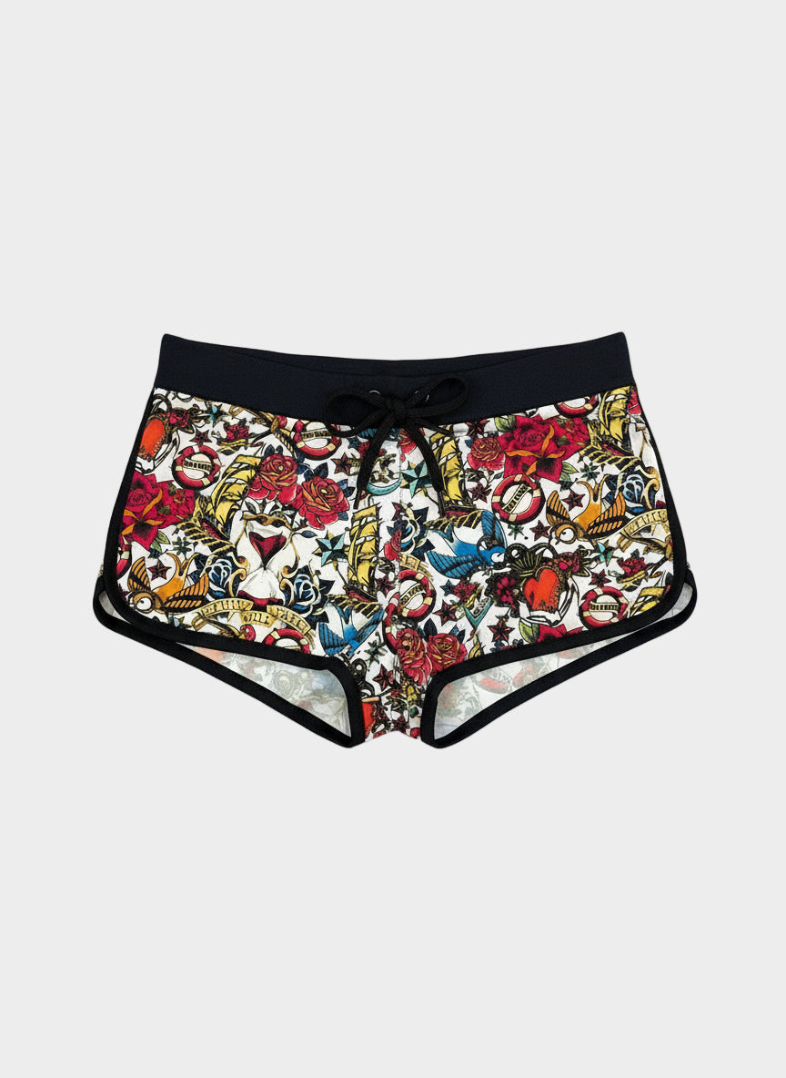 Shorts with a colorful tattoo-style pattern on a gray background