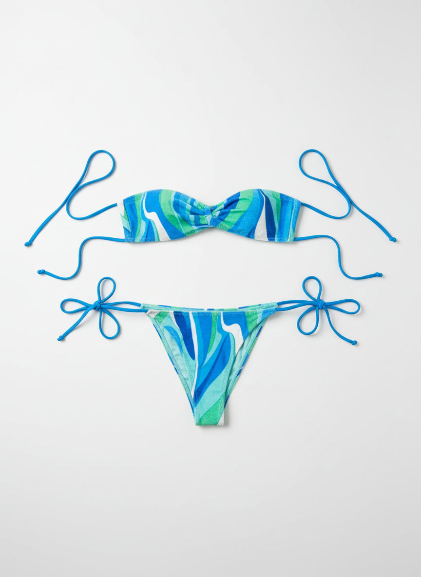 Blue and green bikini set on a tiled floor with tags attached.