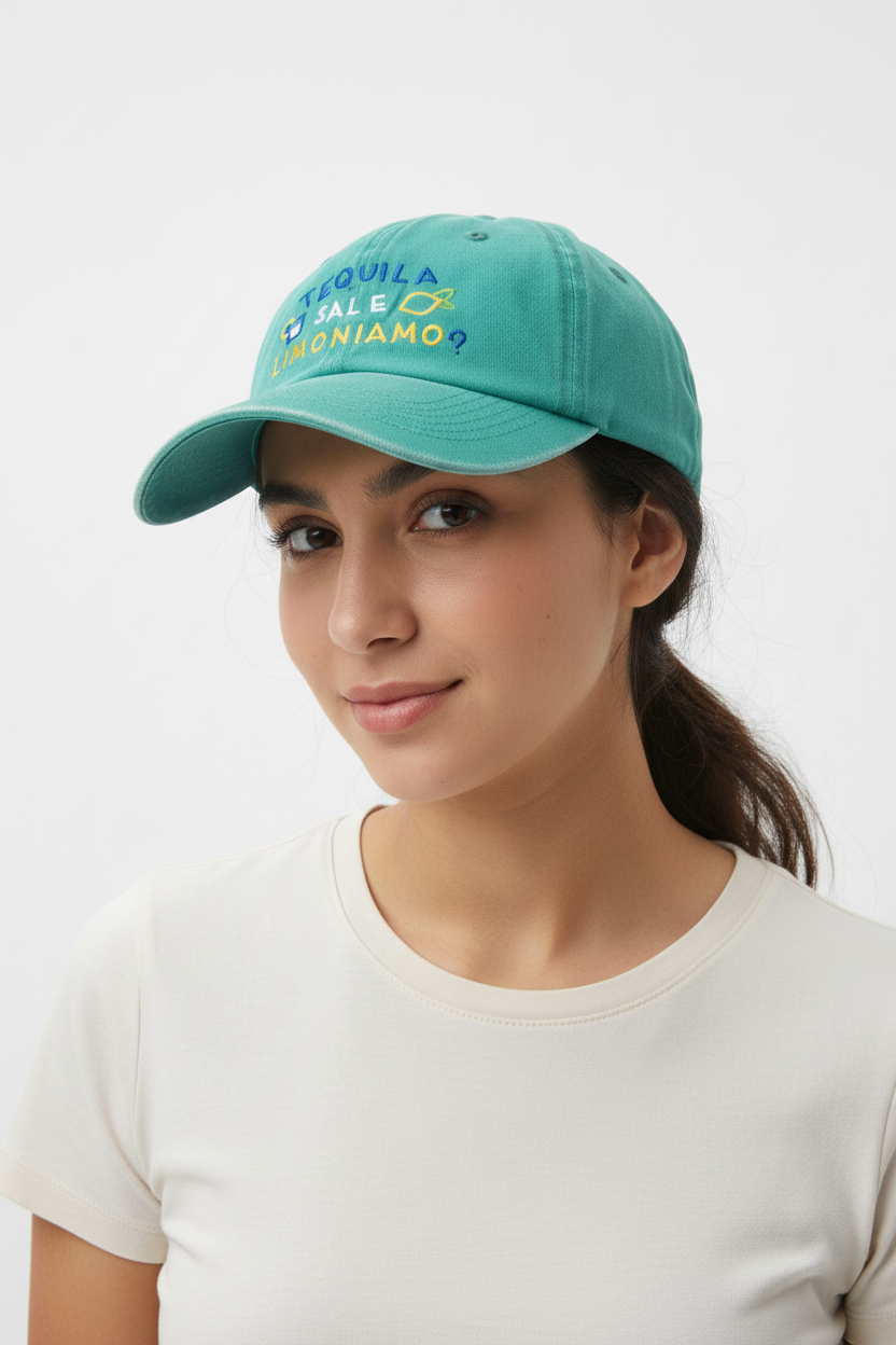 Green cap with text and fish graphics on a tiled floor