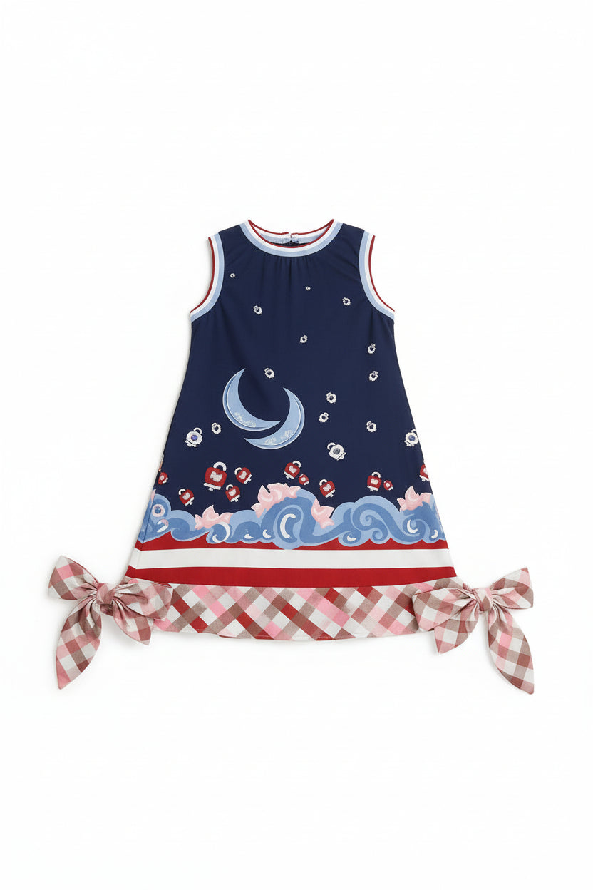 Young girl wearing a dress with a blue and red pattern on a white background