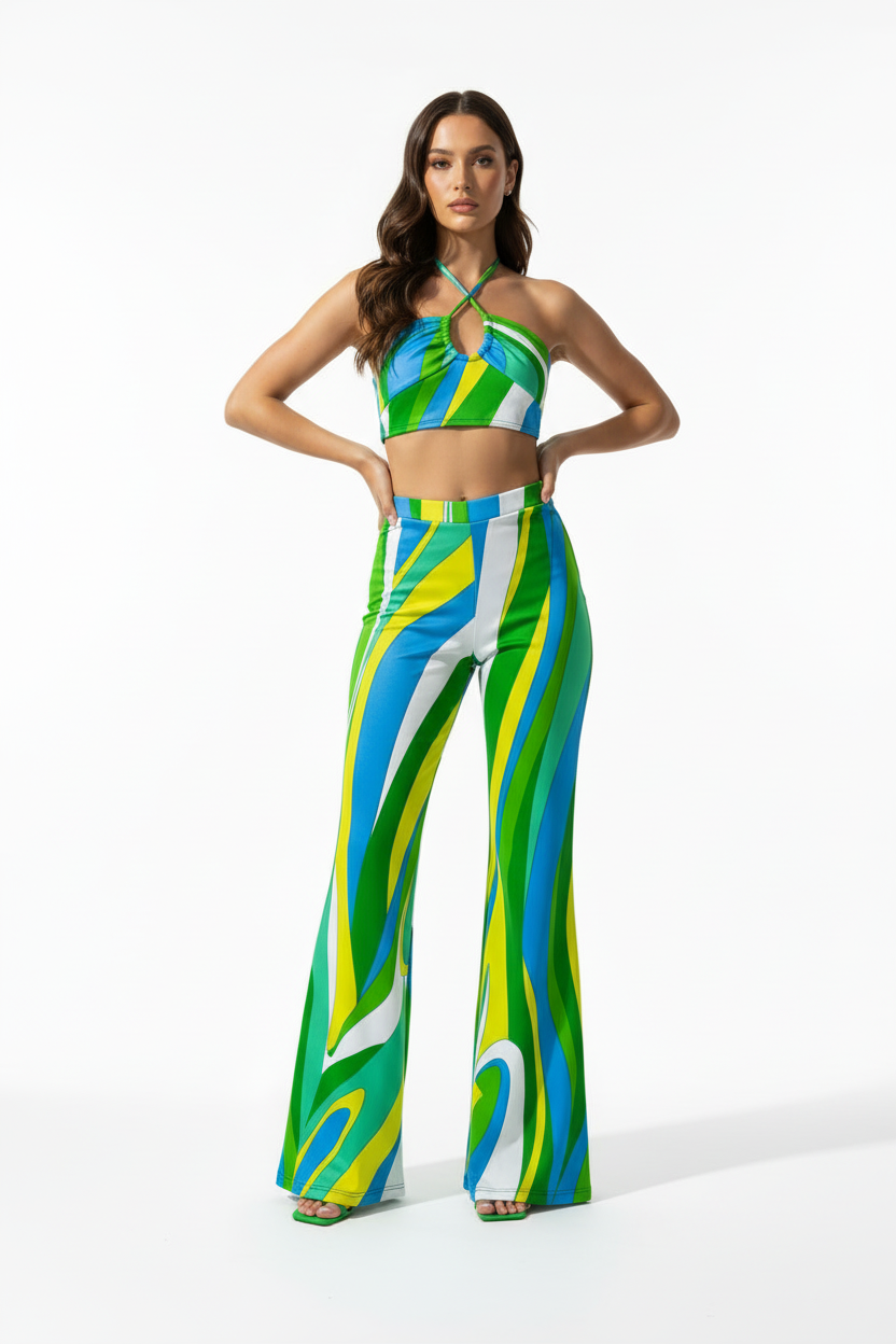 Woman wearing a colorful outfit with a halter top and flared pants on a white background